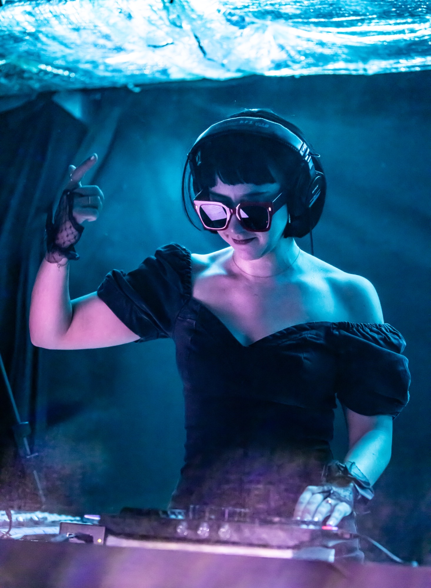 Marika Countouris DJing under blue stage light
